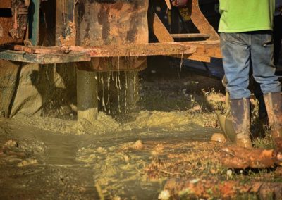 men drilling a well with the help of a machine