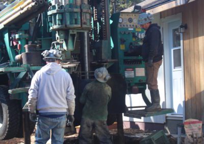 men working with well drilling machine