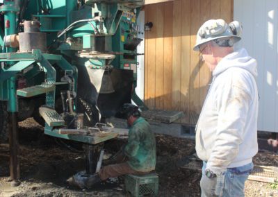 men checking well drilling machine